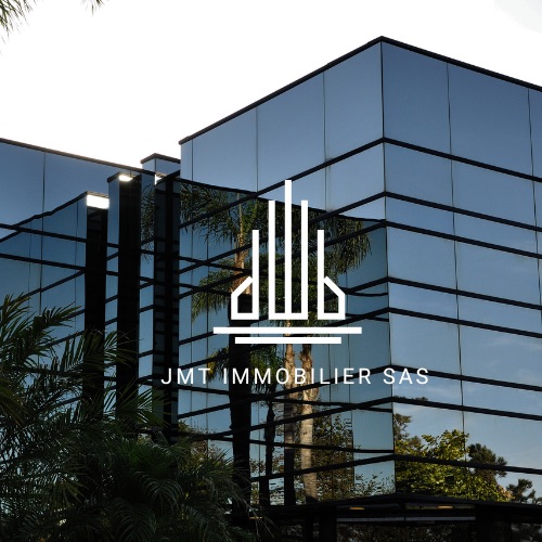 Façade vitrée moderne avec logo JMT IMMOBILIER